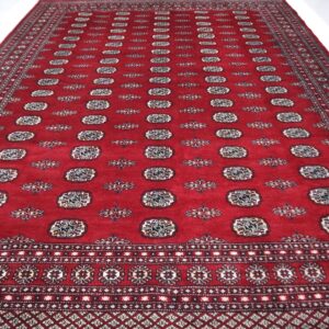 Handmade wool and cotton area rug or runner with repeated geometric Bokhara pattern displayed on floor