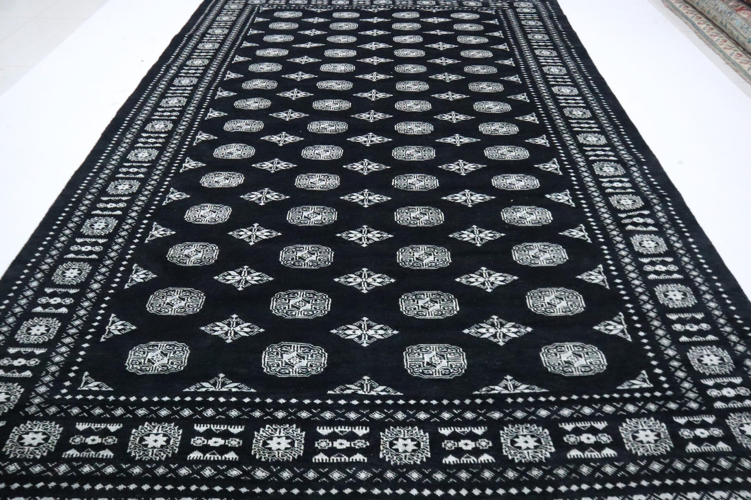 8160 (1) Handmade wool and cotton area rug or runner with repeated geometric Bokhara pattern displayed on floor