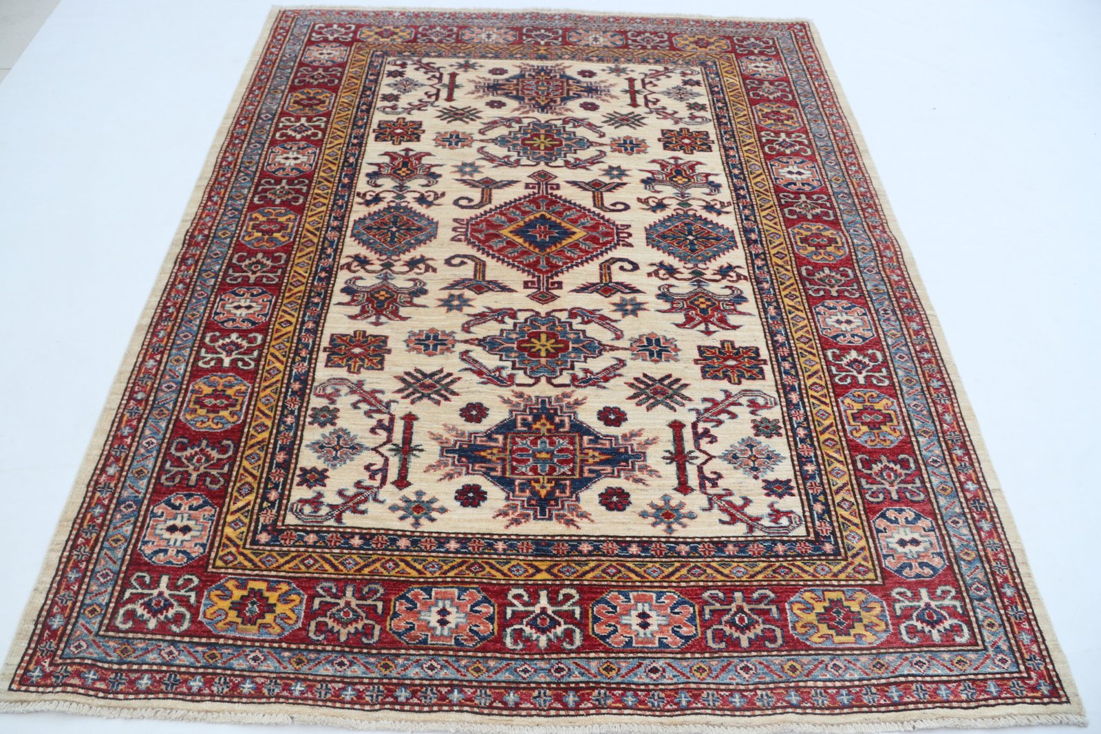 img 5019 Handmade wool and cotton area rug or runner with traditional geometric Kazak pattern displayed on floor