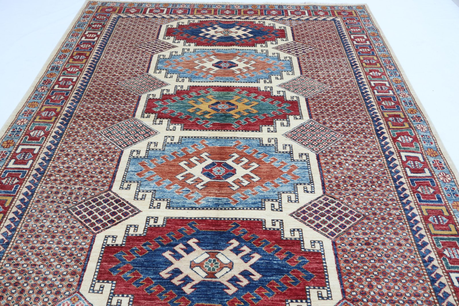 img 5112 Handmade wool and cotton area rug or runner with traditional geometric Kazak pattern displayed on floor