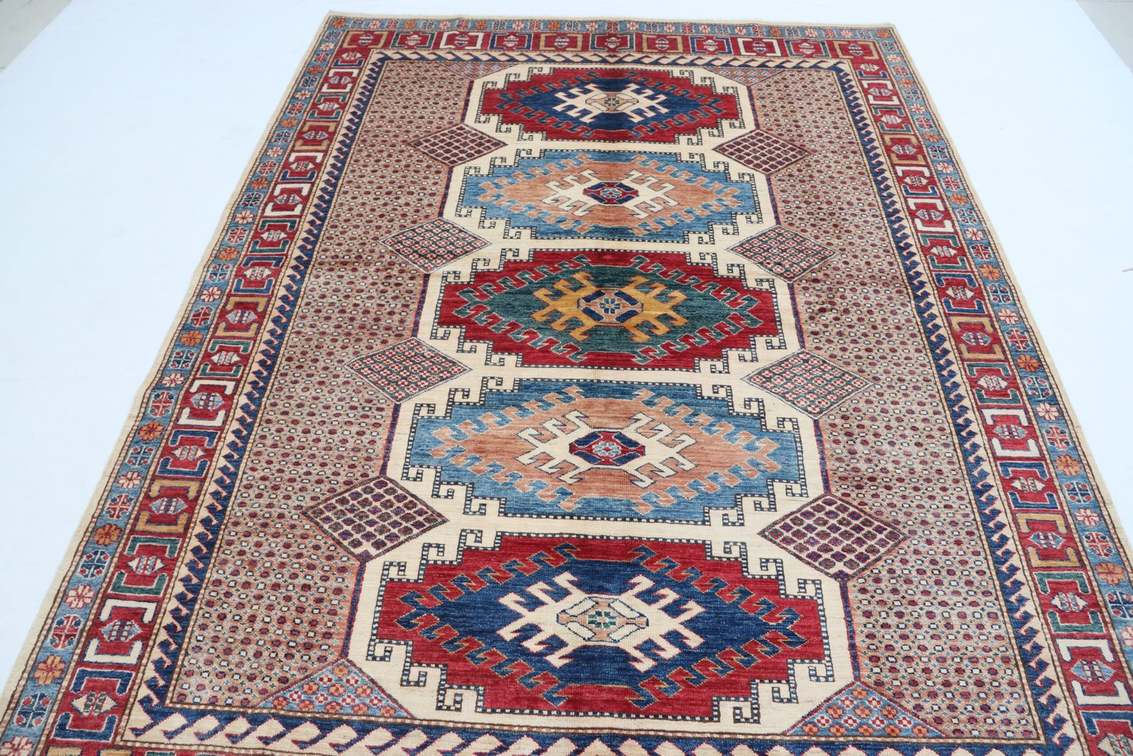 img 5165 Handmade wool and cotton area rug or runner with traditional geometric Kazak pattern displayed on floor