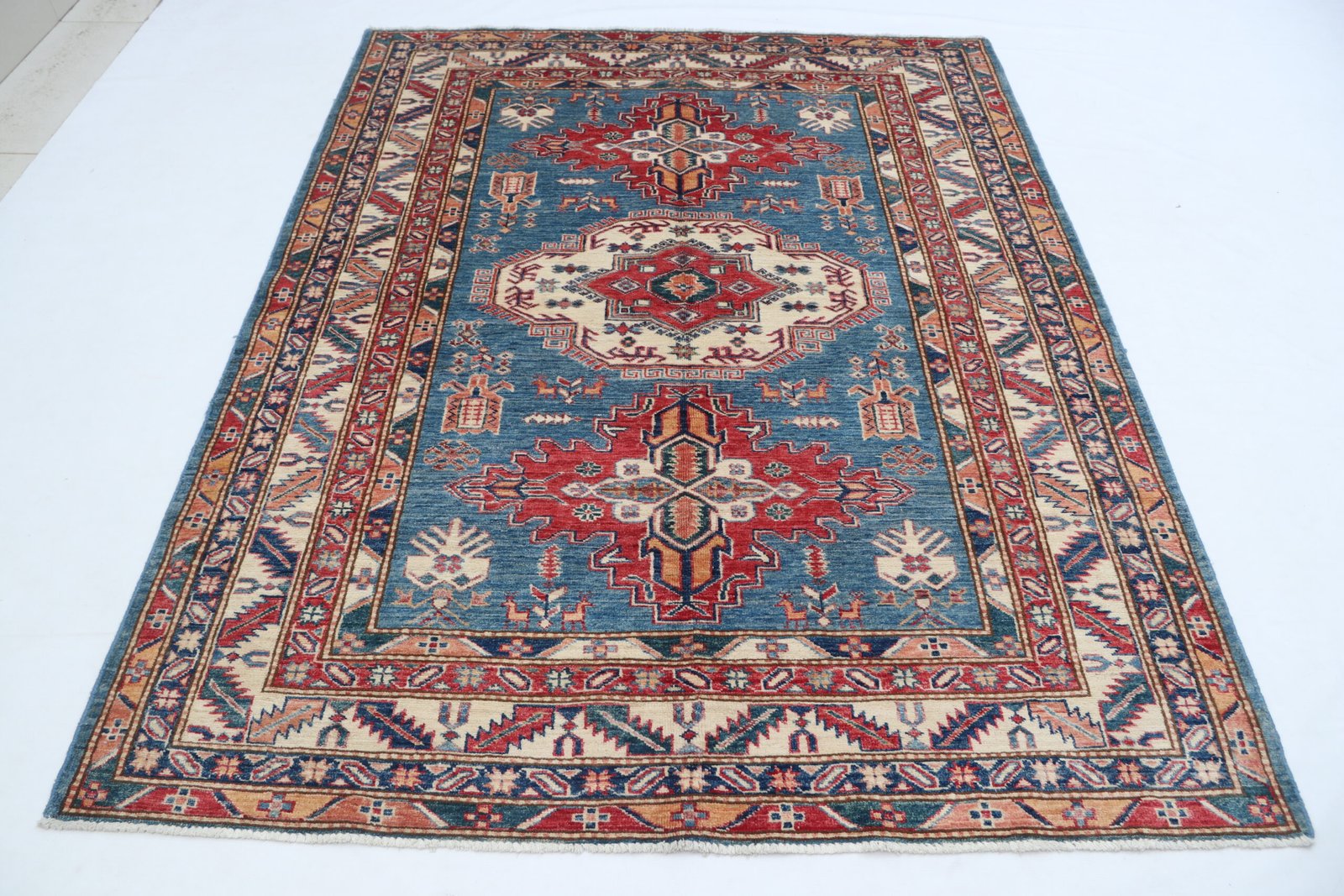 img 5295 Handmade wool and cotton area rug or runner with traditional geometric Kazak pattern displayed on floor