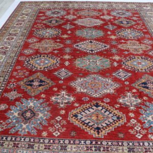 Handmade wool and cotton area rug or runner with traditional geometric Kazak pattern displayed on floor