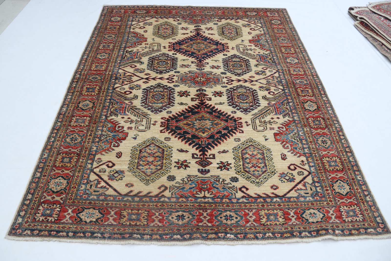 img 5423 Handmade wool and cotton area rug or runner with traditional geometric Kazak pattern displayed on floor