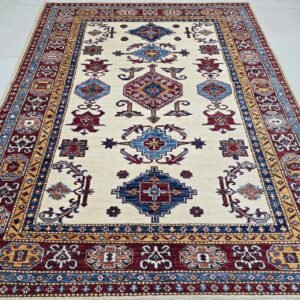Handmade wool and cotton area rug or runner with traditional geometric Kazak pattern displayed on floor