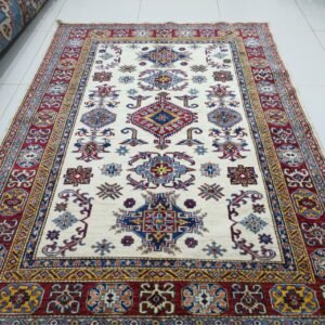 Handmade wool and cotton area rug or runner with traditional geometric Kazak pattern displayed on floor3.38.53 pm (2)