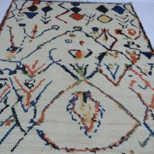 Handmade wool and cotton area rug or runner with repeated geometric Morocan pattern displayed on floor