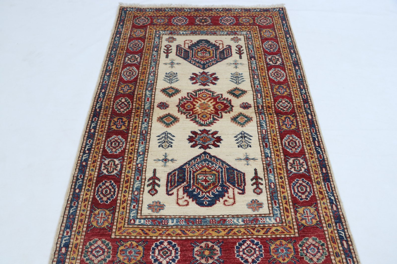 img 4834 Handmade wool and cotton area rug or runner with traditional geometric Kazak pattern displayed on floor