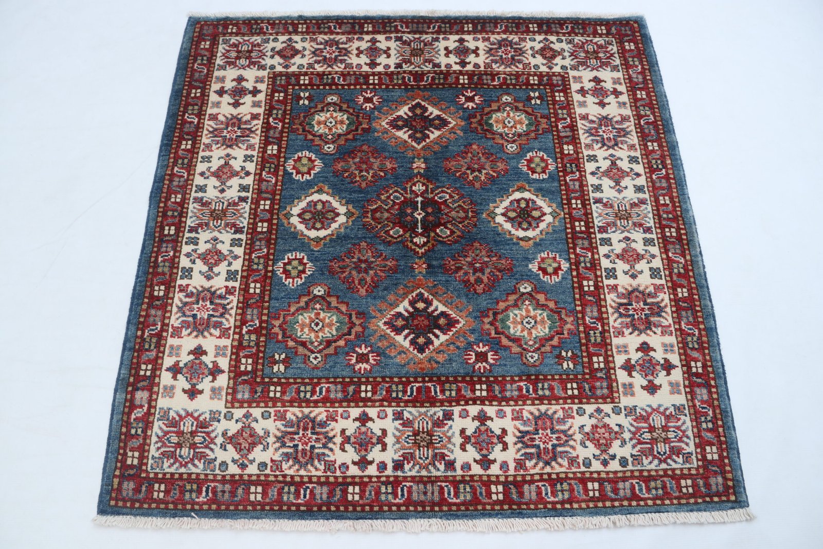 img 4882 Handmade wool and cotton area rug or runner with traditional geometric Kazak pattern displayed on floor