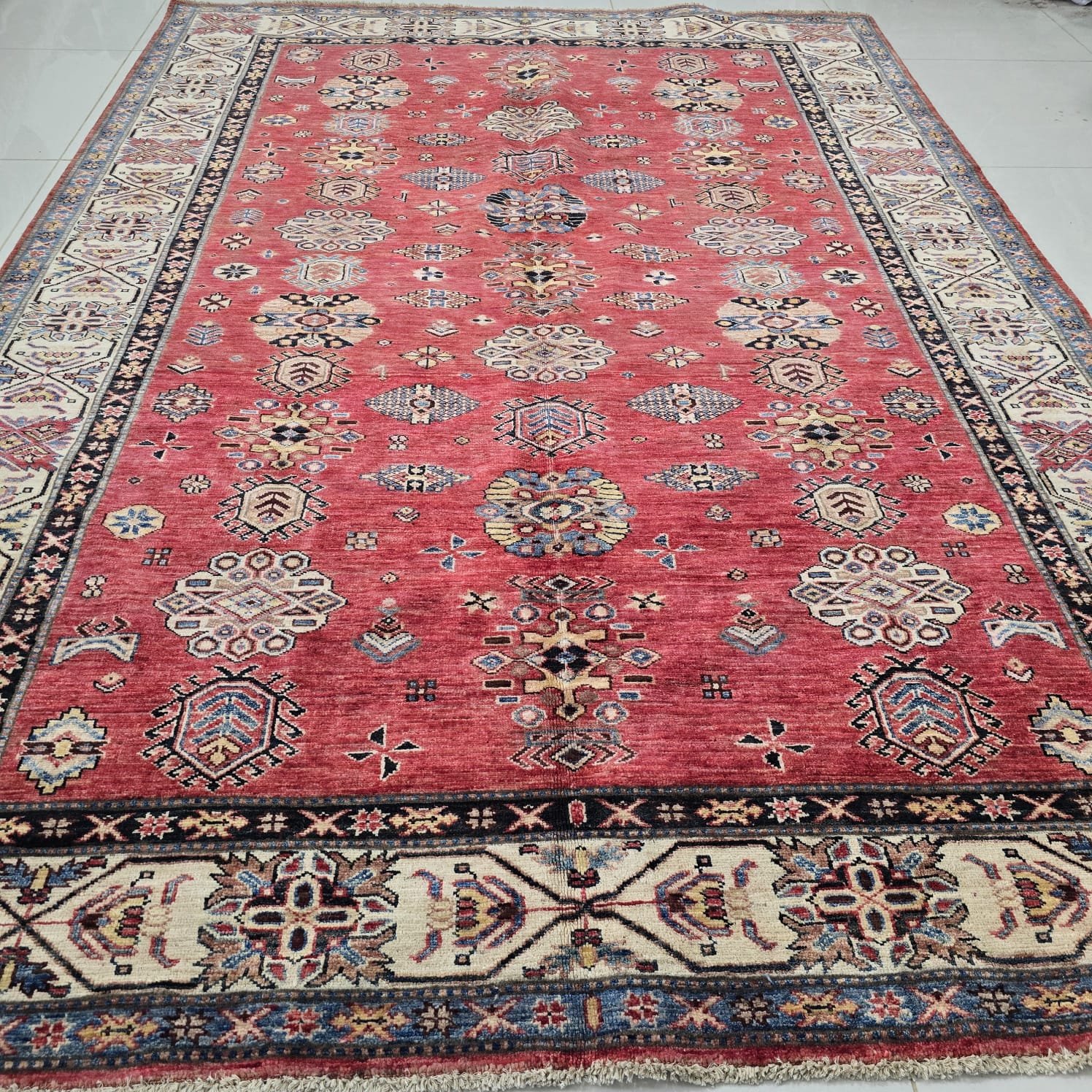 whatsapp image 2026 08 20 at 5.01.01 pm Handmade wool and cotton area rug or runner with traditional geometric Kazak pattern displayed on floor