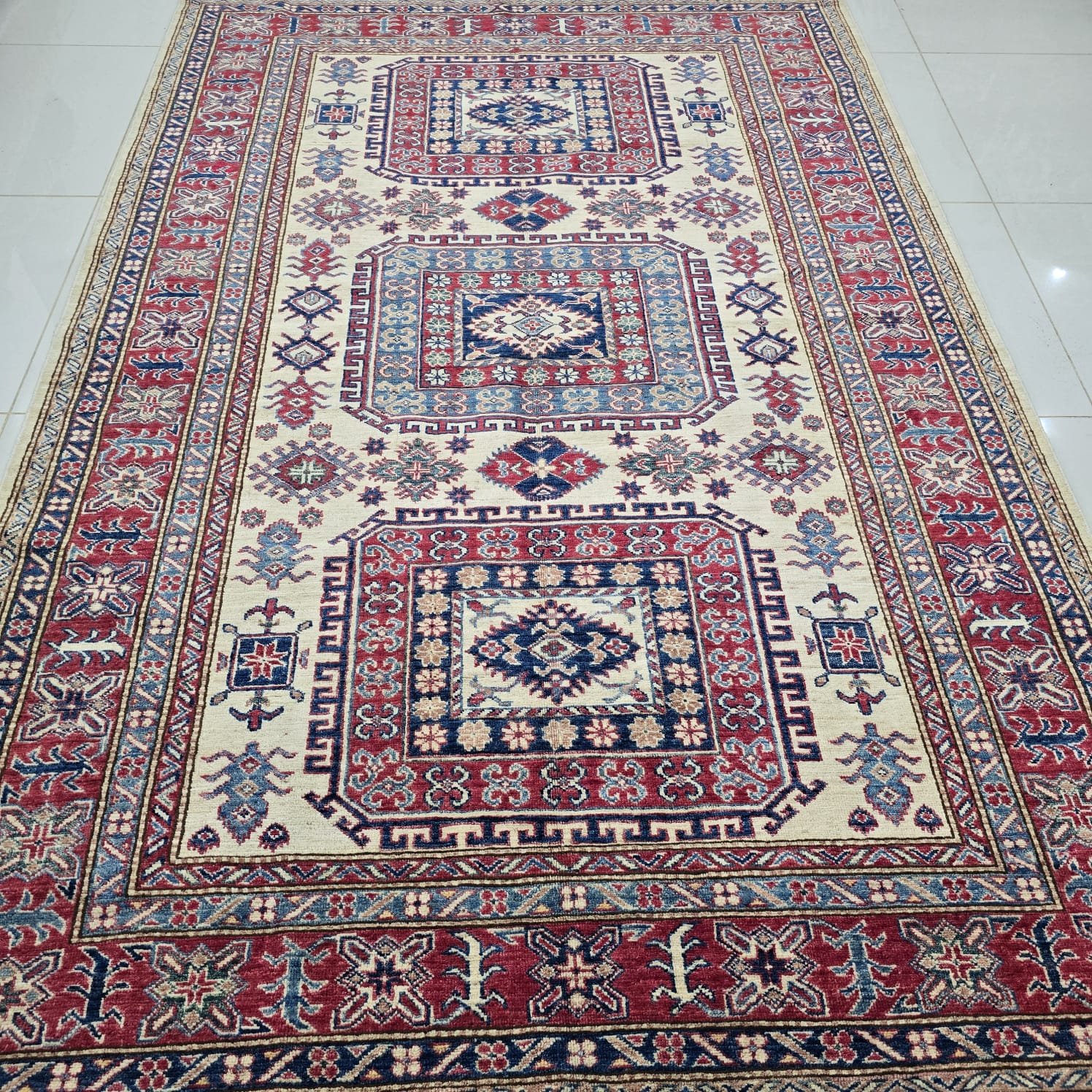 whatsapp image 2026 08 20 at 5.10.38 pm Handmade wool and cotton area rug or runner with traditional geometric Kazak pattern displayed on floor