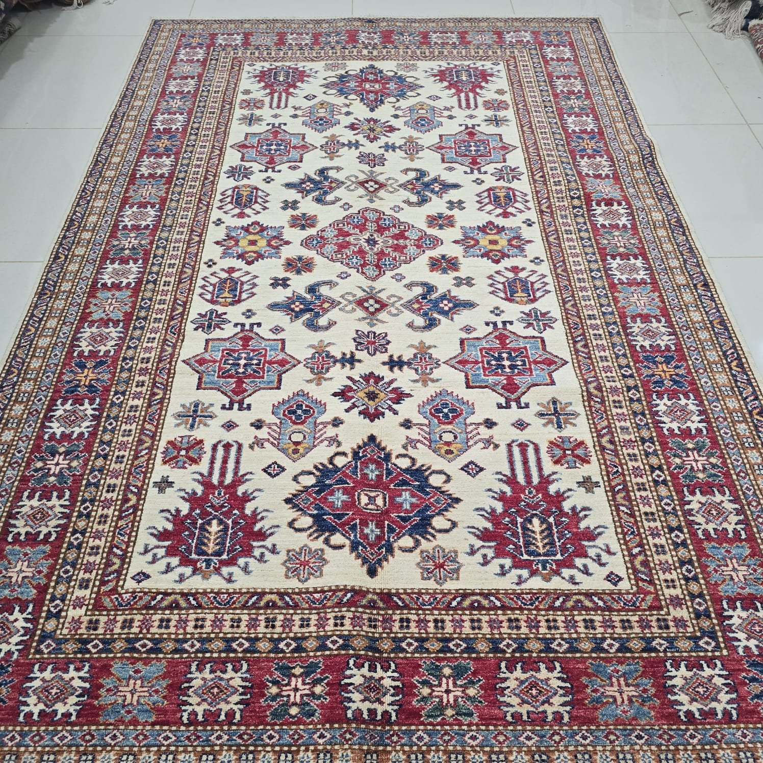 whatsapp image 2026 08 20 at 5.16.26 pm (2) Handmade wool and cotton area rug or runner with traditional geometric Kazak pattern displayed on floor