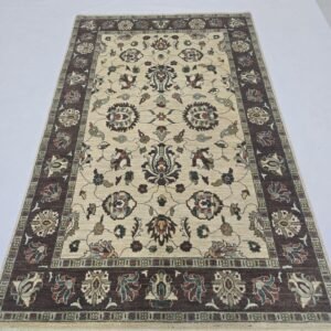 Handmade wool and cotton area rug or runner with classic floral Tribal pattern displayed on floor