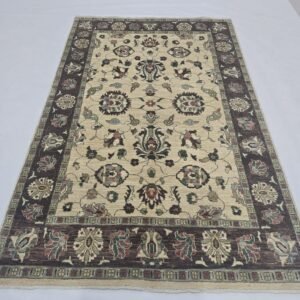 Handmade wool and cotton area rug or runner with classic floral Tribal pattern displayed on floor