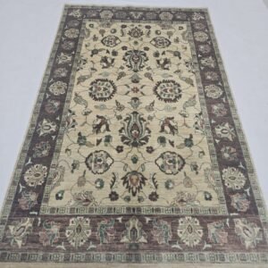 Handmade wool and cotton area rug or runner with classic floral Tribal pattern displayed on floor