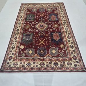 Handmade wool and cotton area rug or runner with classic floral Tribal pattern displayed on floor